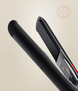 Close-up of the Astral Black Omnia Styler Classic, showing its open plates and colour-coded temperature controls.