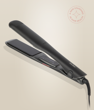 Astral Black Omnia Styler Max lying open, with its plates and control panel visible.