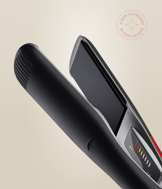 Close-up of the Astral Black Omnia Styler Max, showing its open plates and colour-coded temperature controls.