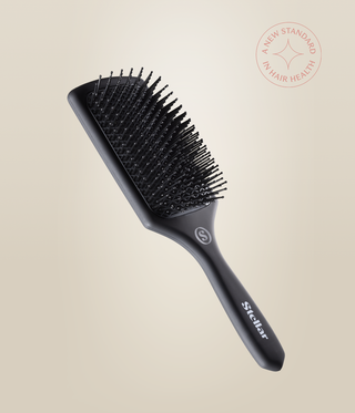 Black MicroCell Cushion Brush with a rectangular head, ball-tipped bristles and Stellar-branded handle.