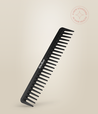 Black Carbon Dressing Comb resting at an angle, with widely spaced teeth and a white Stellar logo.