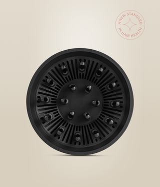 Front view of the black OmniFlex Dryer diffuser, showing its circular vents and raised fingers.