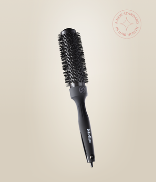 Black HeatSense Round Brush with a vented cylindrical barrel, bristles and Stellar-branded handle.
