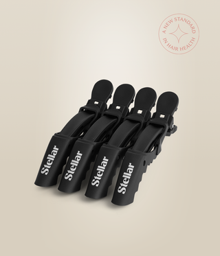 Four black Stellar sectioning clips resting together with their white logos facing forward.