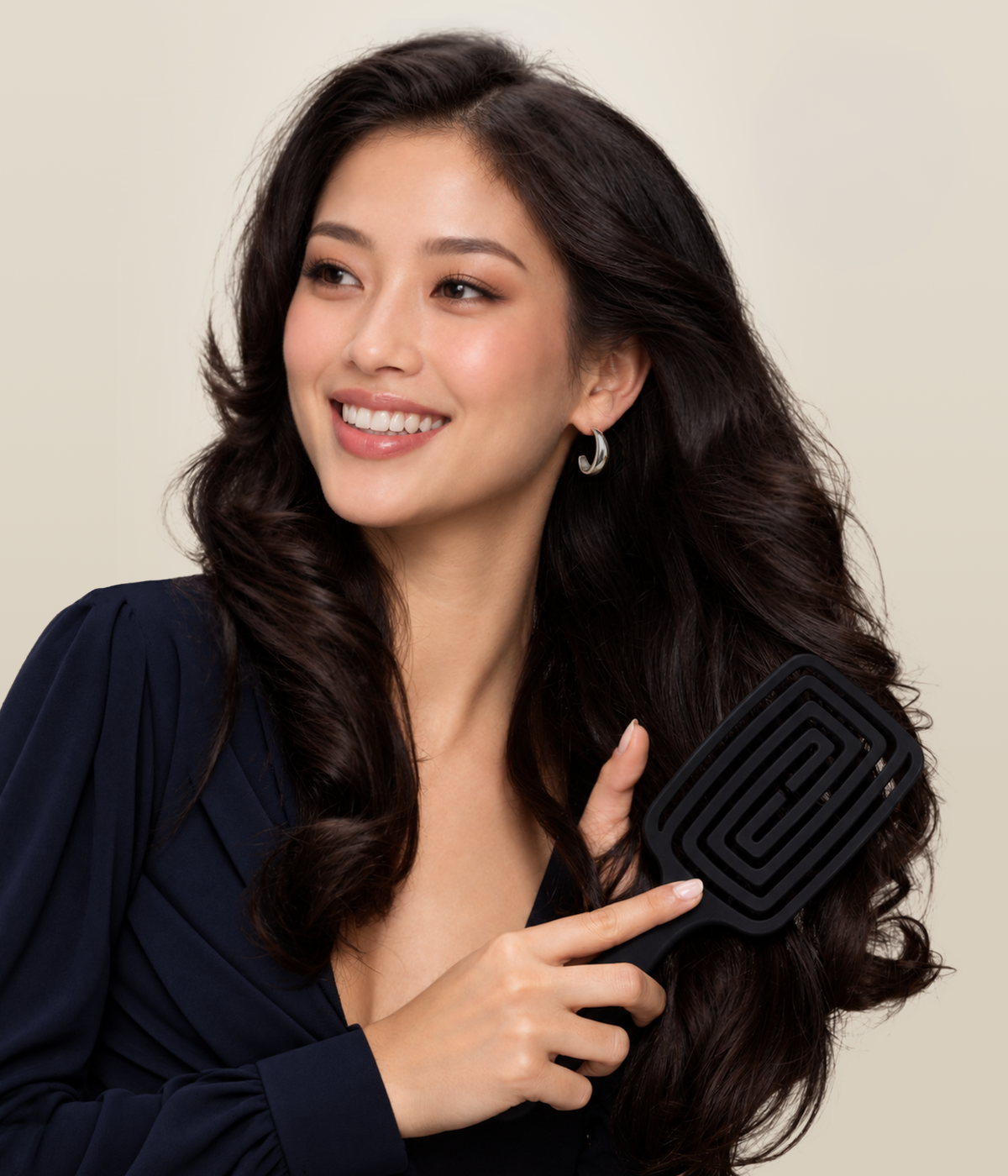 Smiling woman with dark wavy hair holding the complete black Stellar OmniFlex Vent Brush.